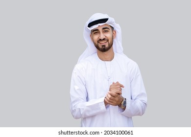 Young handsome Emirati business man in UAE traditional outfit showing a variety of hand gesture. Arabic ambitious mature businessman.