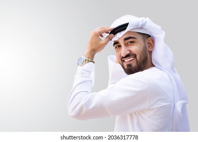 Young handsome Emirati businessman in UAE traditional outfit showing a variety of hand gesture. Arabic ambitious mature businessman.