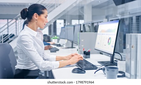 Young Handsome Female Manager is Working on Her Personal Computer with Data Statistics, Charts and Graphs. Diverse and Motivated Business People Work in Bright Modern Open Office. - Shutterstock ID 1798791964