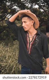 A young handsome Filipino man in a boho style polo shirt and hat. Casual portait, outdoor scene. - Shutterstock ID 2278172919