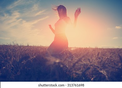 Young and handsome girl dancing outdoors at sunset