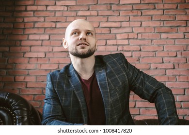 Young handsome guy seating, and looking forward, selective focus