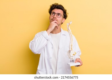young handsome guy thinking  feeling doubtful   confused  spine specialist concept