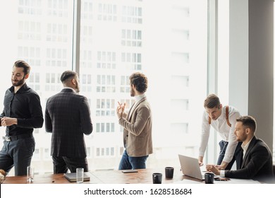 young handsome guys in tux hold meeting in office, successful people discuss strategies, projects and ideas. business coworking in conference room