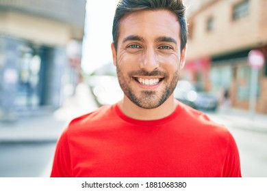 Young Handsome Hispanic Man Smiling Happy. Standing With Smile On Face Walking At Town Street.