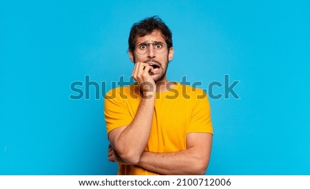 young handsome indian man scared expression