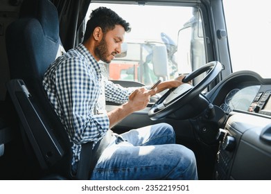 Young handsome indian man using smart phone in his truck