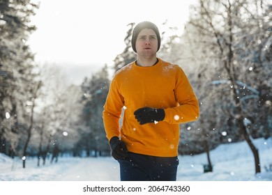 Young And Handsome Jogger Man During His Workout In Winter Park