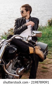 Young Handsome Male Biker Is Sitting And Smoking On Motor Bike