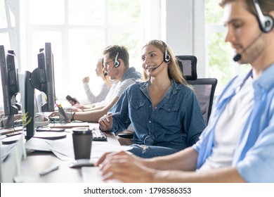 Young Handsome Male Customer Support Phone Operator With Headset Working In Call Center