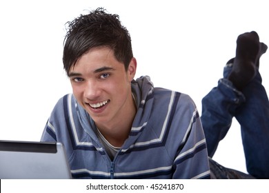 Young Handsome Male Student Lying On Floor With Computer Laptop And Is Surfing In The Internet. Isolated On White.