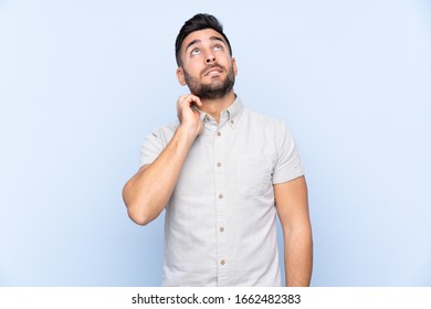 Young handsome man with beard over isolated blue background thinking an idea - Shutterstock ID 1662482383