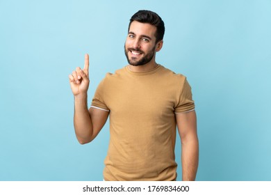 Young handsome man with beard over isolated background showing and lifting a finger in sign of the best - Shutterstock ID 1769834600