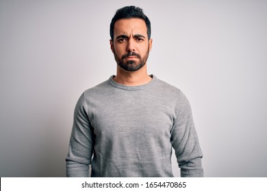 Young Handsome Man With Beard Wearing Casual Sweater Standing Over White Background Depressed And Worry For Distress, Crying Angry And Afraid. Sad Expression.