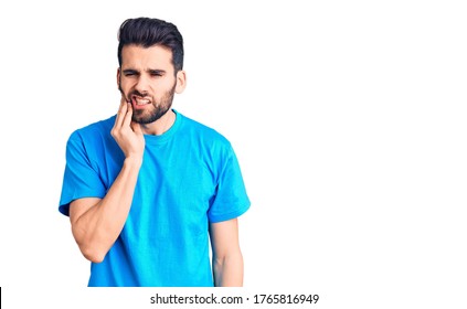 Young Handsome Man With Beard Wearing Casual T-shirt Touching Mouth With Hand With Painful Expression Because Of Toothache Or Dental Illness On Teeth. Dentist 