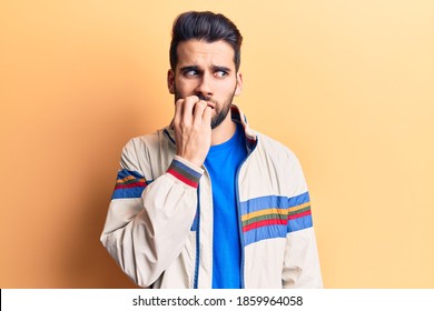 Young handsome man with beard wearing casual jacket looking stressed and nervous with hands on mouth biting nails. anxiety problem. 