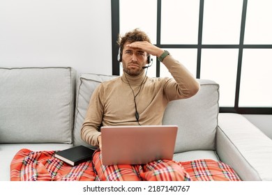 Young Handsome Man With Beard Wearing Operator Headset Working From Home Worried And Stressed About A Problem With Hand On Forehead, Nervous And Anxious For Crisis 