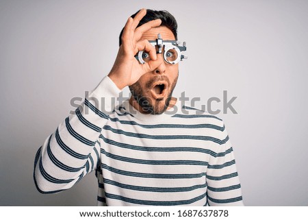 Similar – Man observing something through binoculars