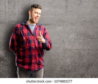 Young Handsome Man Blinking Eyes With Happy Gesture