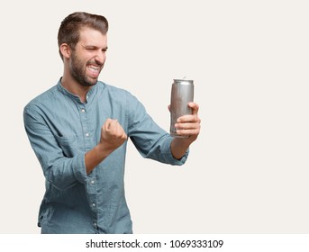 Young Handsome Man, Blue Denim Shirt, Holding A Beer Pint, Dancing Or Celebrating Expression . Person Isolated Against Monochrome Background