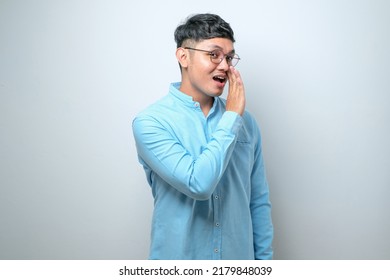 Young handsome man casual shirt and glasses over white background hand on mouth telling secret rumor, whispering malicious talk conversation - Shutterstock ID 2179848039