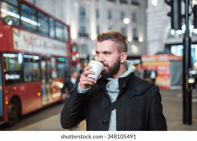 Young handsome man with coffee cup in London city