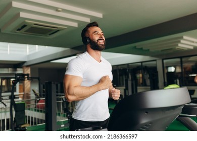 Young handsome man doing cardio exercises with treadmill in gym with fitness health club - Powered by Shutterstock