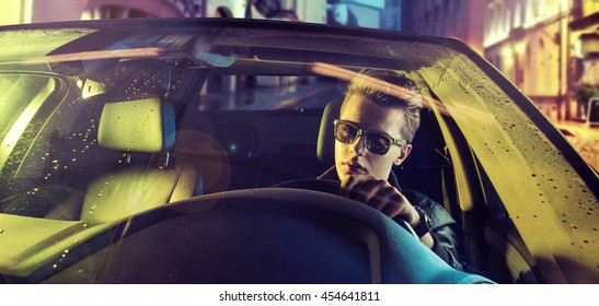 Young Handsome Man Driving Car At Night