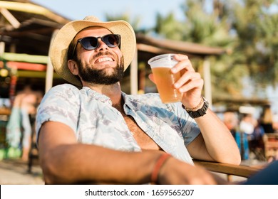 Young Handsome Man Enjoying Beer In Beach Bar