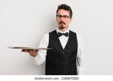 Young Handsome Man Feeling Sad, Upset Or Angry And Looking To The Side. Waiter And Tray Concept