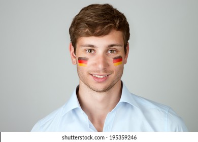 young handsome man with flag of germany painting at face - Powered by Shutterstock