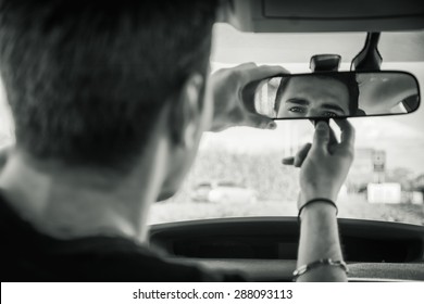 Young Handsome Man In His Car Adjusting Rear View Mirror During Day