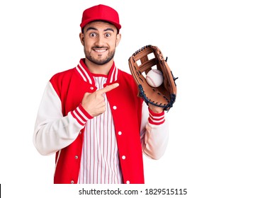 Young handsome man holding baseball gloves smiling happy pointing with hand and finger  - Powered by Shutterstock