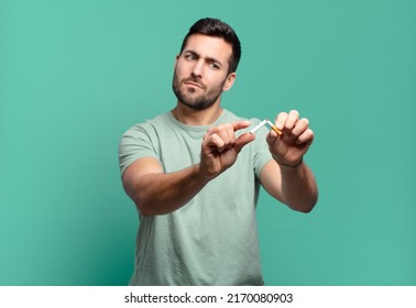 Young Handsome Man Holding A Cigarette. Quit Smoking Concept