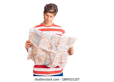 Young Handsome Man Holding City Map Thinking Attitude And Sober Expression Looking Self Confident 