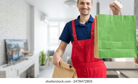 Young handsome man holding delivery paper bag - Powered by Shutterstock