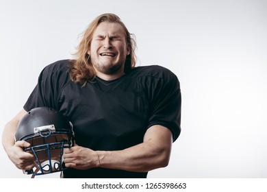 Young handsome man with long hair over isolated background holding football ball stressed with hand on head, shocked with shame and surprise face, angry and frustrated. Fear and upset for mistake. - Powered by Shutterstock