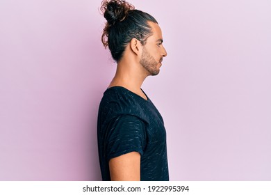 Young handsome man with long hair wearing casual clothes looking to side, relax profile pose with natural face with confident smile.  - Powered by Shutterstock