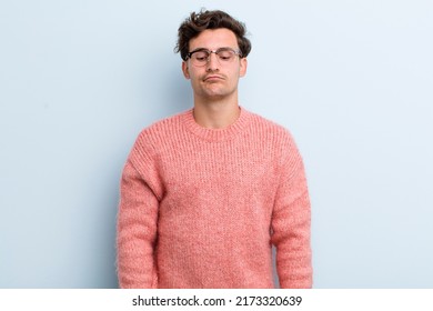 Young Handsome Man Looking Goofy And Funny With A Silly Cross-eyed Expression, Joking And Fooling Around