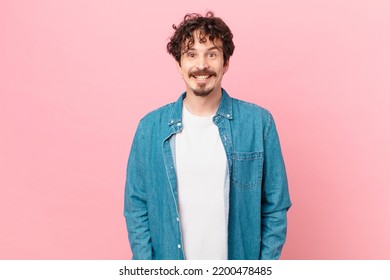 Young Handsome Man Looking Happy And Pleasantly Surprised