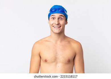 Young Handsome Man Looking Happy And Pleasantly Surprised. Swimmer Concept