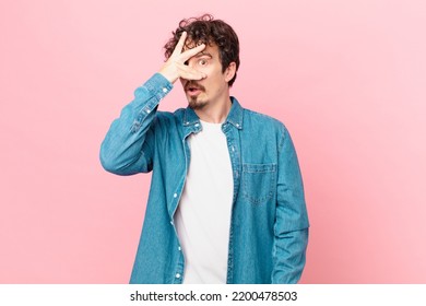 Young Handsome Man Looking Shocked, Scared Or Terrified, Covering Face With Hand