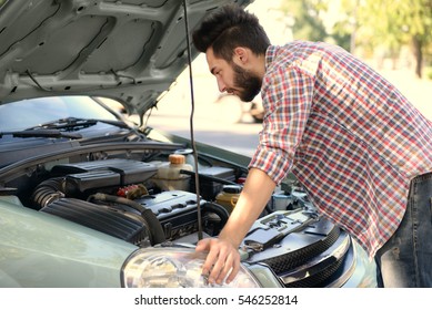 Young Handsome Man Looking Under Car Hood