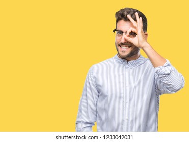 Young handsome man over isolated background doing ok gesture with hand smiling, eye looking through fingers with happy face. - Shutterstock ID 1233042031
