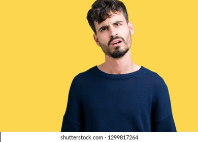 Young handsome man over isolated background In shock face, looking skeptical and sarcastic, surprised with open mouth