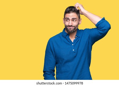 Young handsome man over isolated background confuse and wonder about question. Uncertain with doubt, thinking with hand on head. Pensive concept. - Shutterstock ID 1475099978