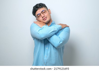 Young Handsome Man Over Isolated White Background Hugging Oneself Happy And Positive, Smiling Confident. Self Love And Self Care