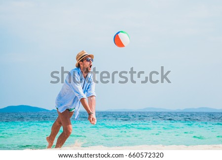 Summer holidays, man with snorkel and volley ball.