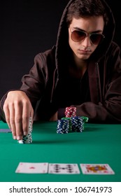 Young handsome man playing texas hold'em poker