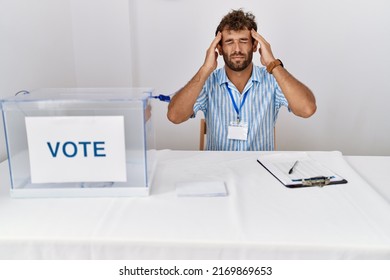 Young Handsome Man At Political Election Sitting By Ballot With Hand On Head For Pain In Head Because Stress. Suffering Migraine. 